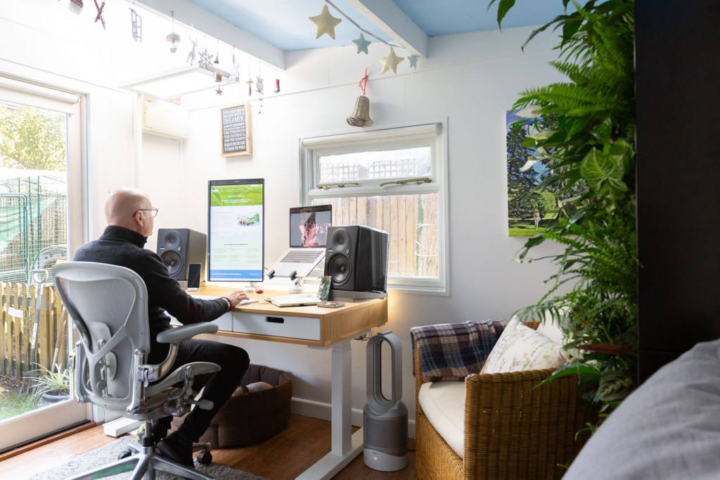 Image of a home-working set up that is ergonomic and has elements of biophilic design