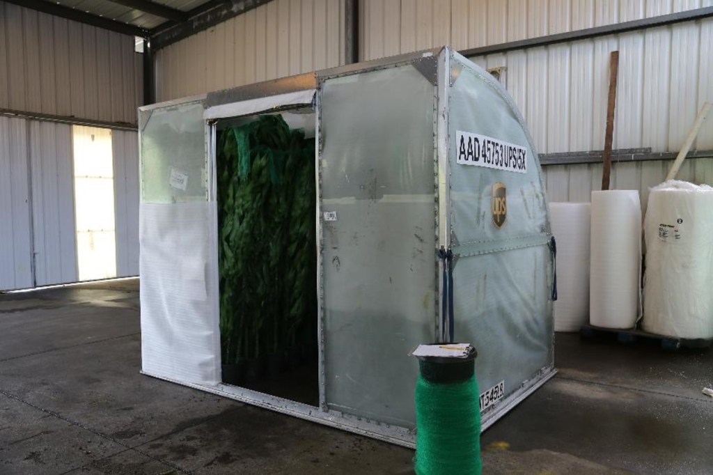 Air transport container loaded with plants