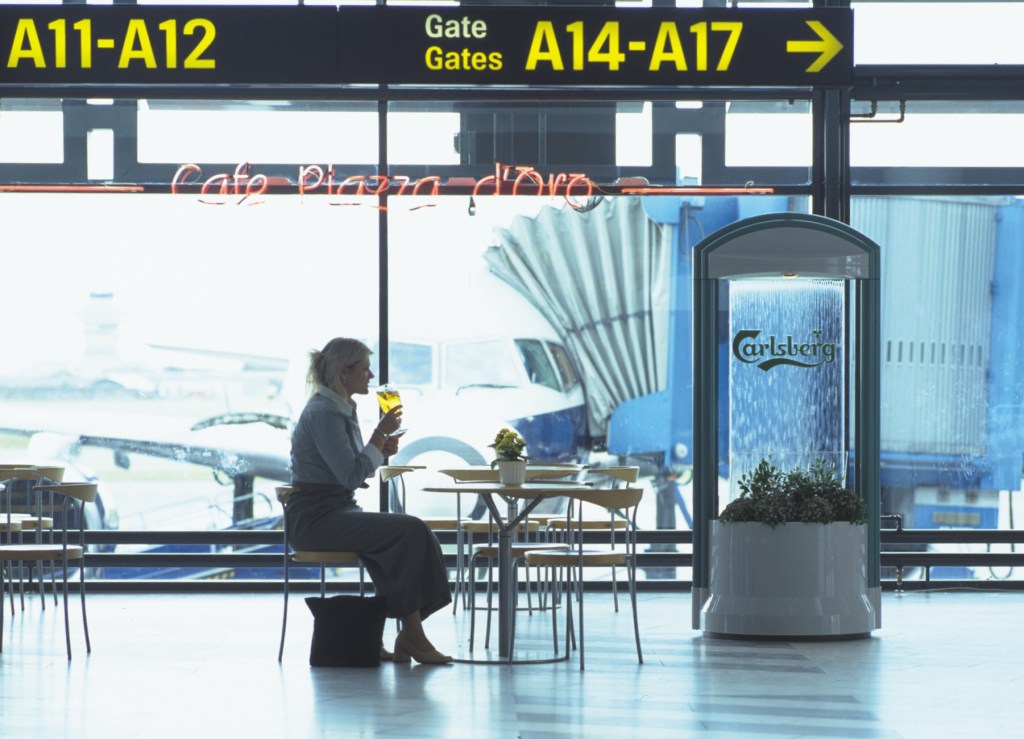 An indoor water feature in an airport providing irregular sounds of falling water